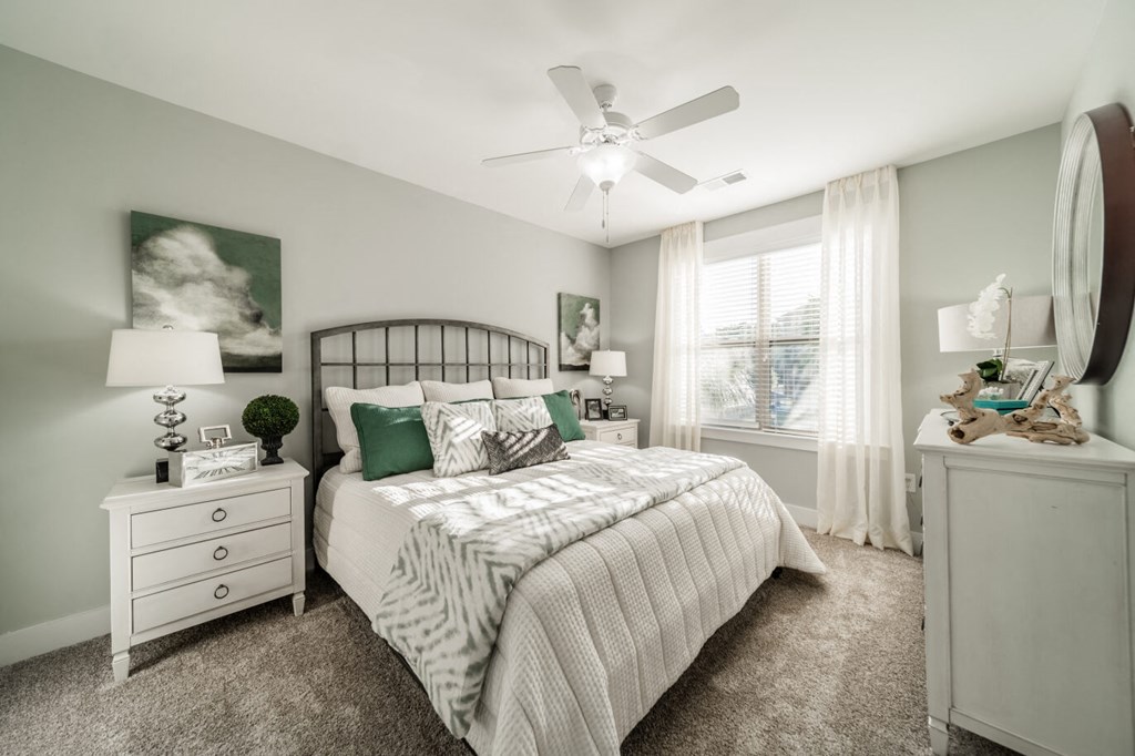 a bedroom with a bed and a ceiling fan
