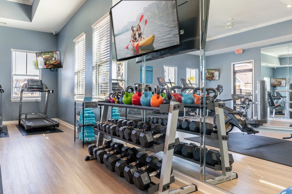 the preserve at ballantyne commons fitness room with weights and a tv