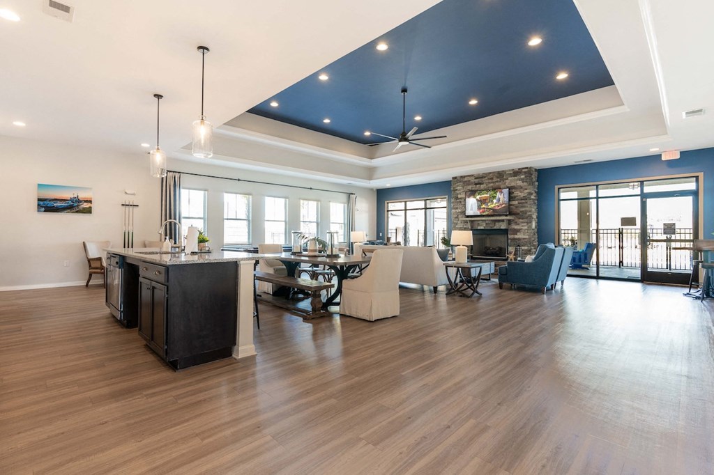 a large living room with a dining room and a fireplace