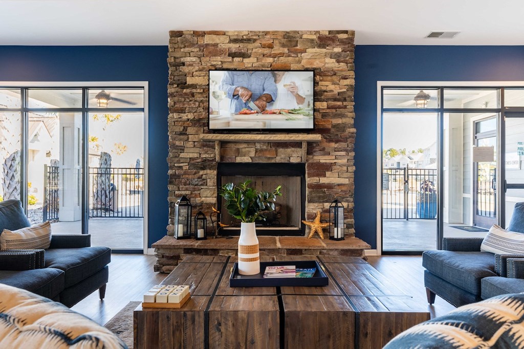 a living room with blue walls and a stone fireplace