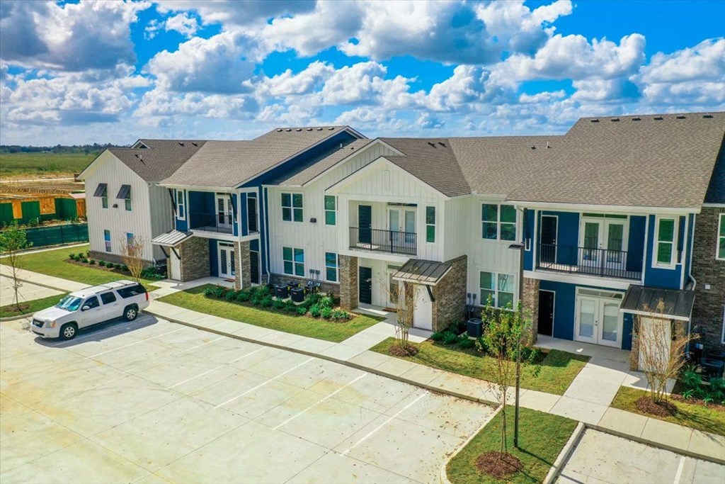 an aerial view of an apartment complex with a car parked in front