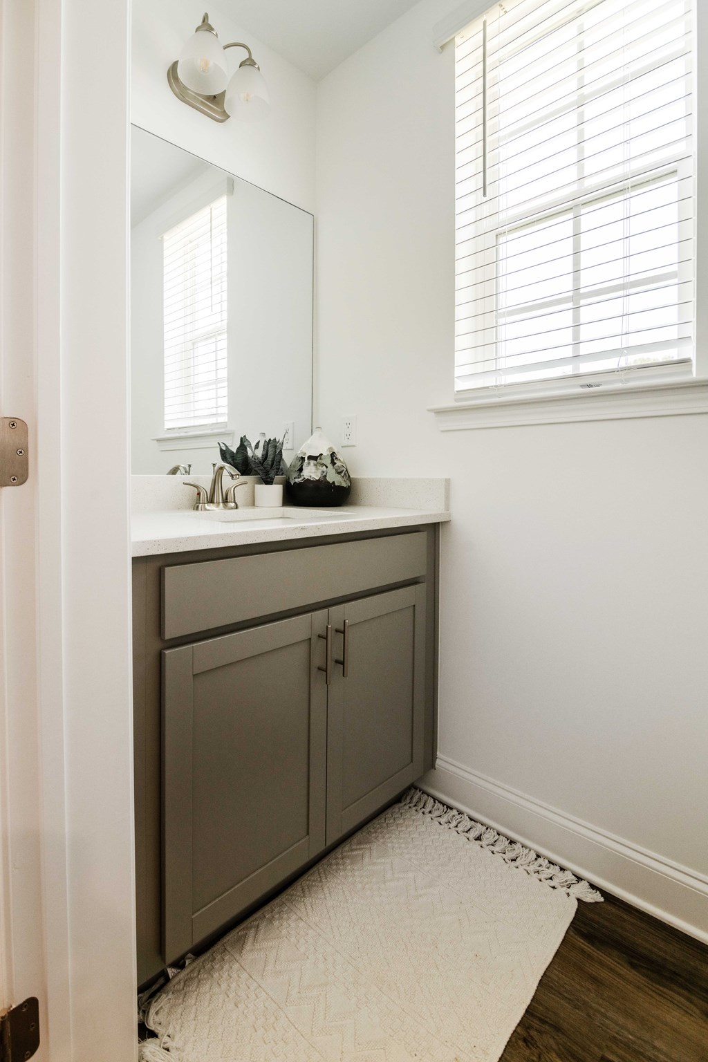 A bathroom with a white sink and a mirror.