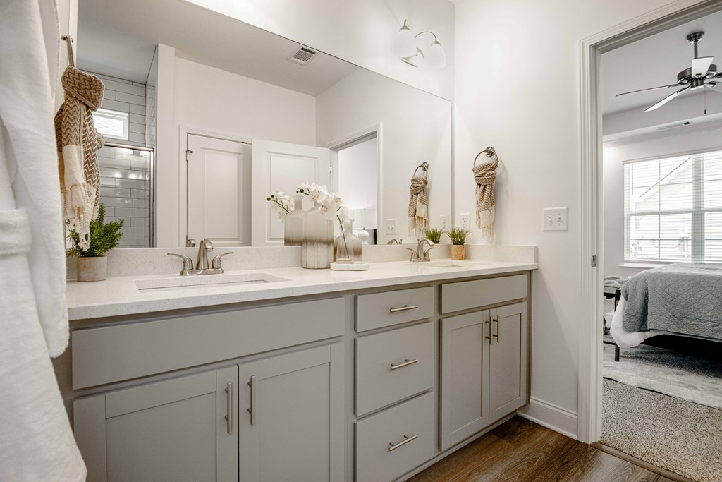 A bathroom with two sinks and a large mirror.