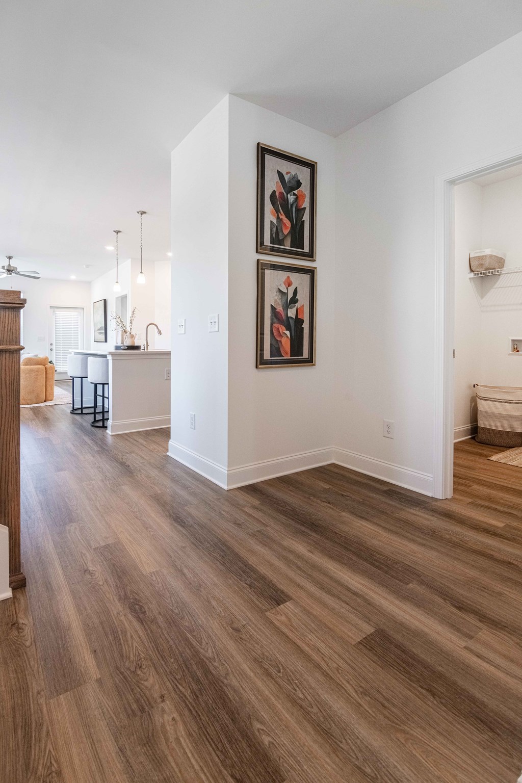 A living room with wood flooring and a painting on the wall.