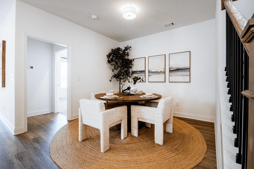 A dining room with a table set for four.
