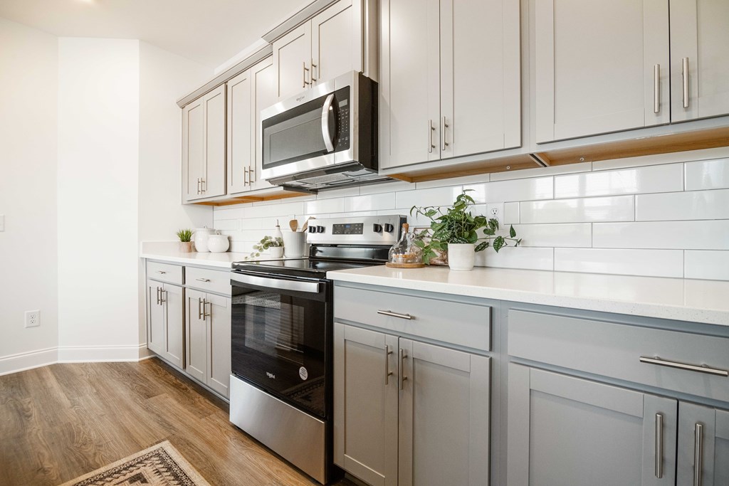 A kitchen with a black oven and a black microwave above it.