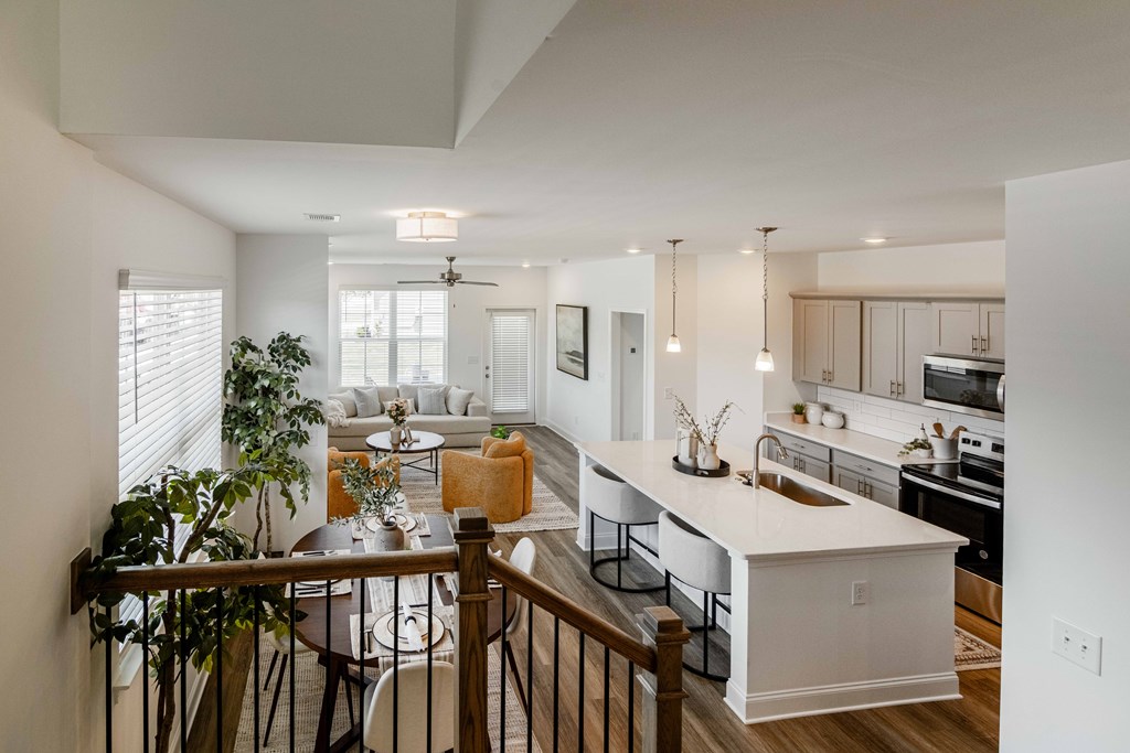 A modern kitchen with a dining table and chairs.