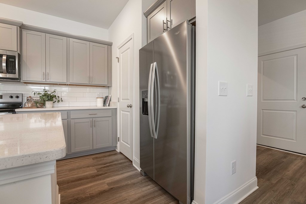 A modern kitchen with a stainless steel refrigerator.