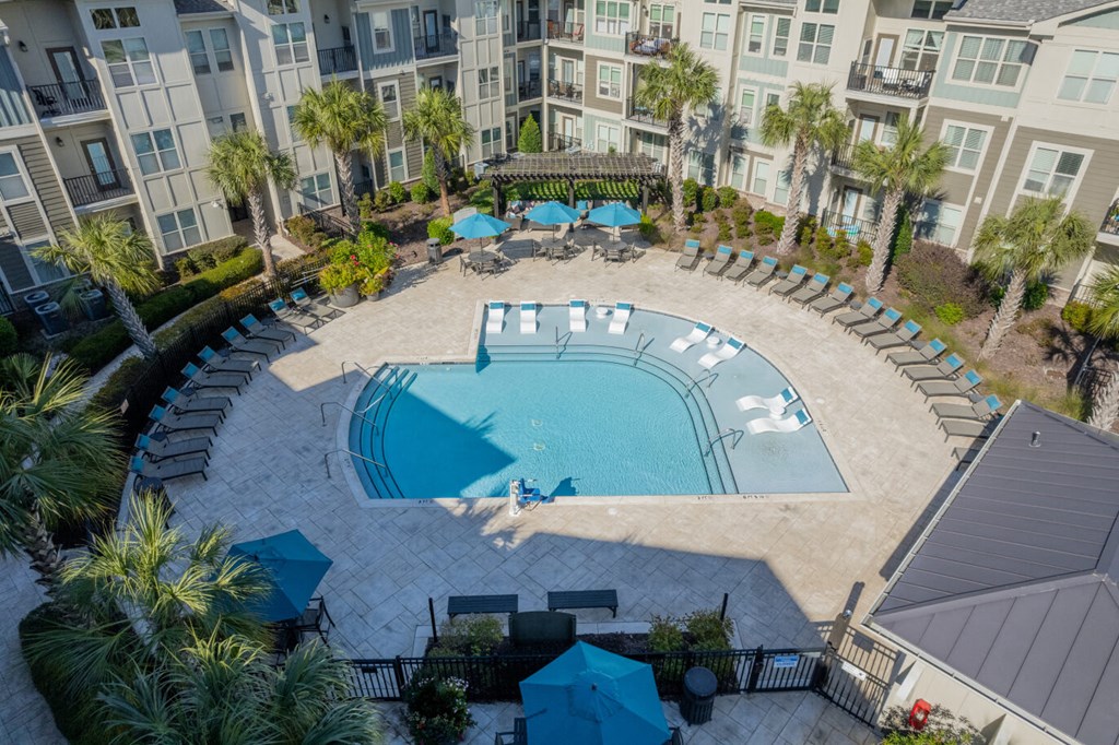 an aerial view of a swimming pool at an apartment complex