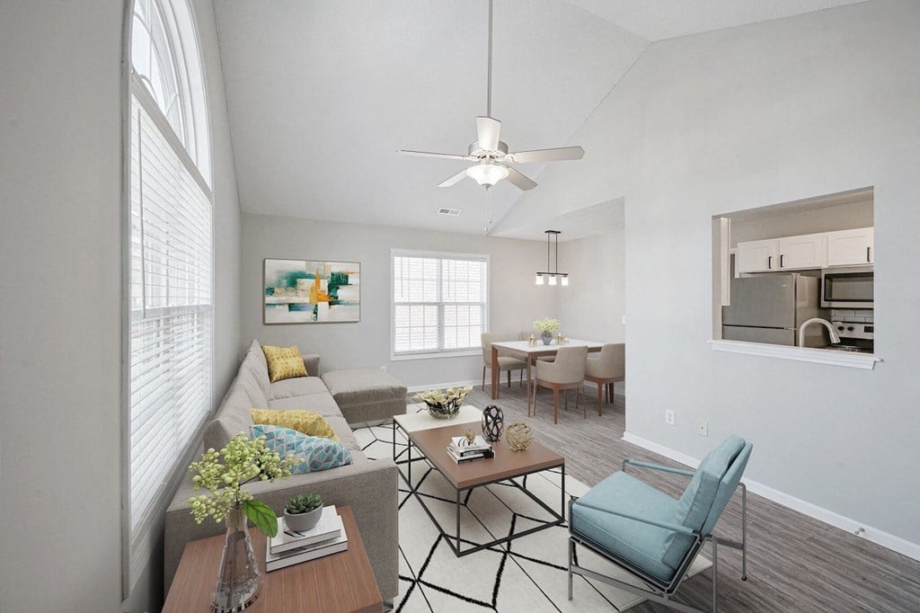 a living room with a couch and a table and a ceiling fan