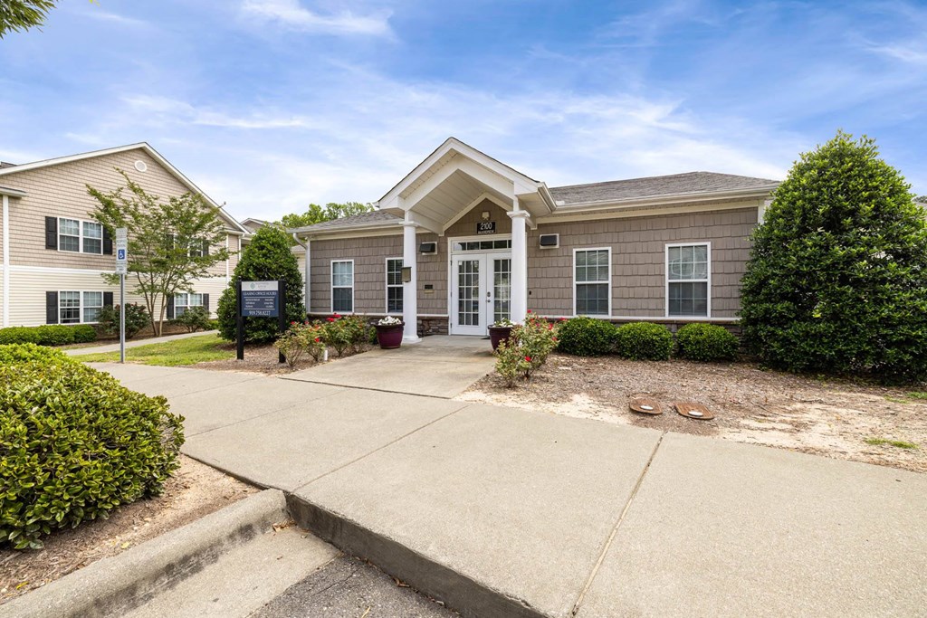 the front of a house with a walkway and a driveway