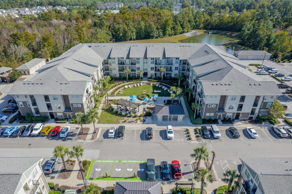 an aerial view of a large building with cars parked in front of it