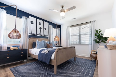 Home Interior A bedroom with a bed, nightstand, and a ceiling fan.
