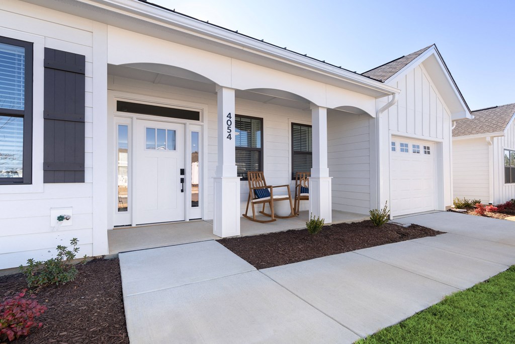A white house with a black door and windows.