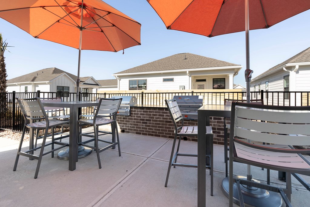 a patio with tables and chairs and umbrellas