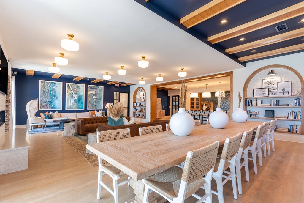 a dining room with a wooden table and white vases on it