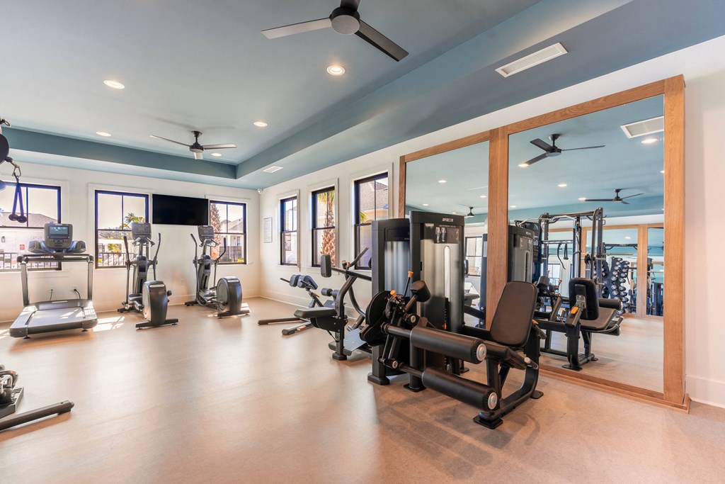 an expansive fitness centers equipped with cardio equipment and free weights