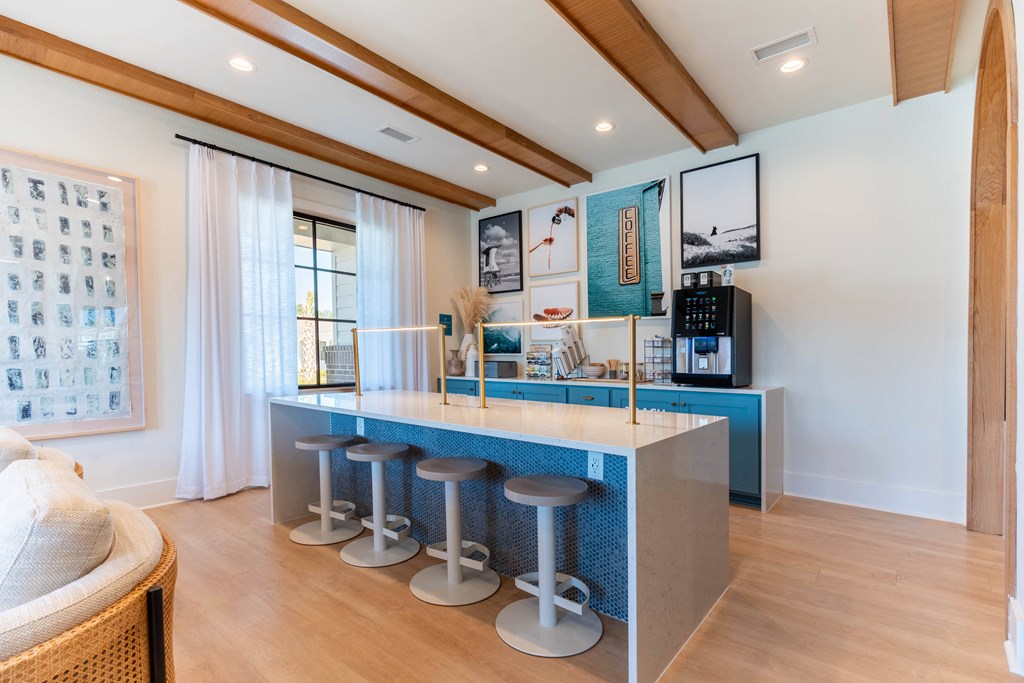 a kitchen with a blue counter top and bar stools