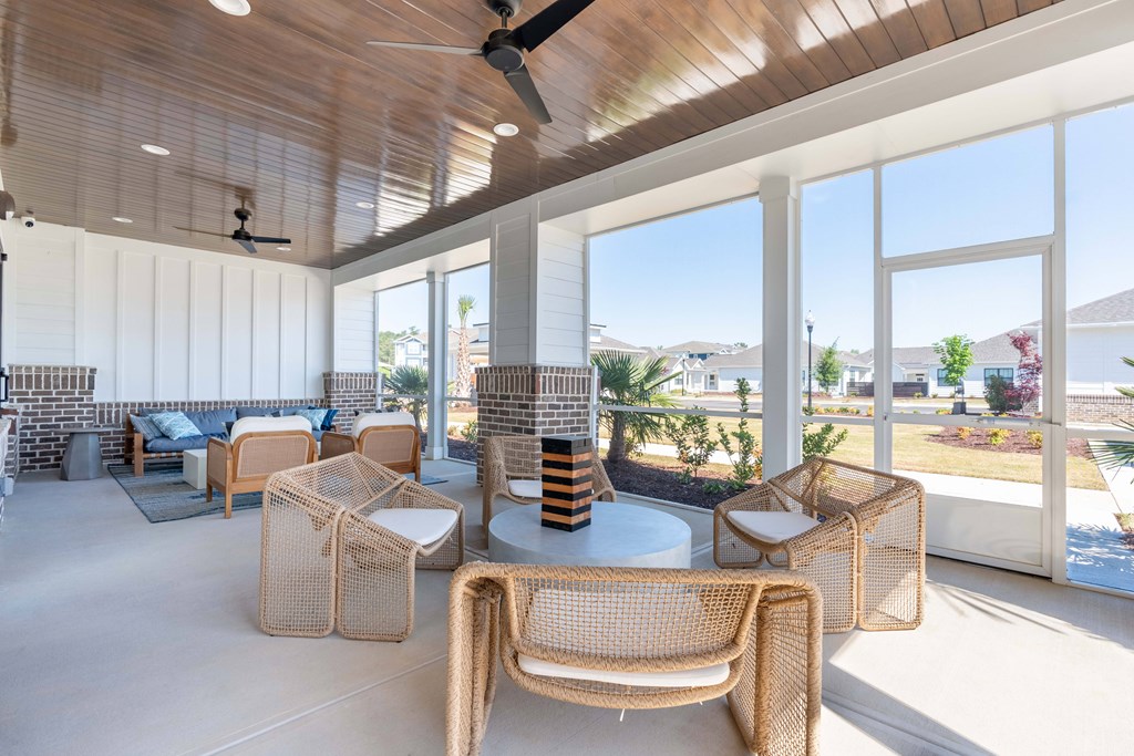 A sunny day at the patio with a table and chairs.