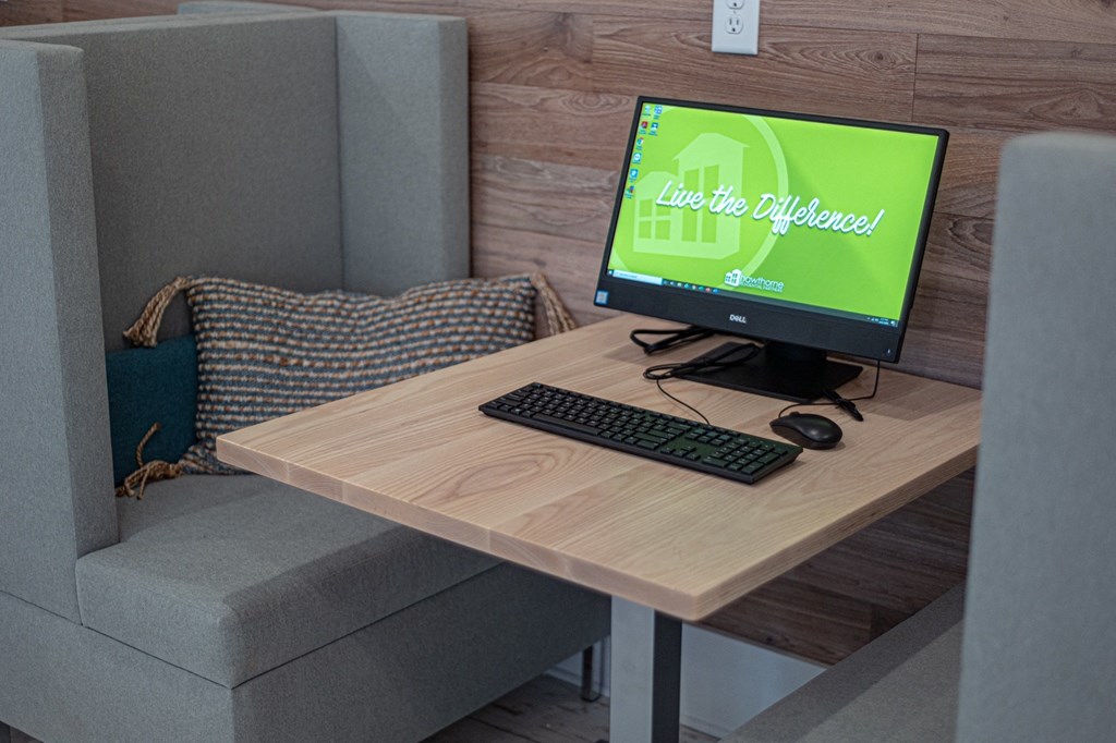 a computer on a desk in a living room