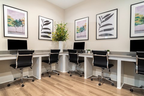 a conference room with desks and chairs and pictures on the wall