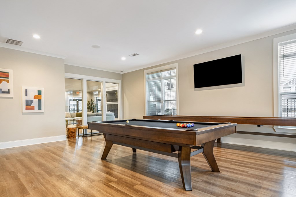a game room with a pool table and a tv