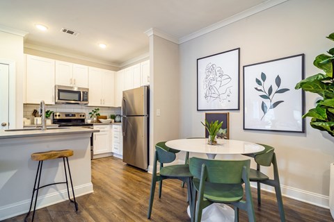 a kitchen and dining room with a table and chairs