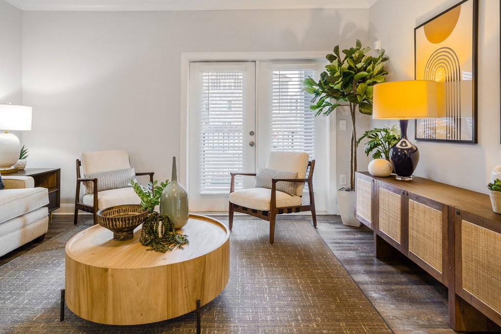 a living room with a table and chairs and a door