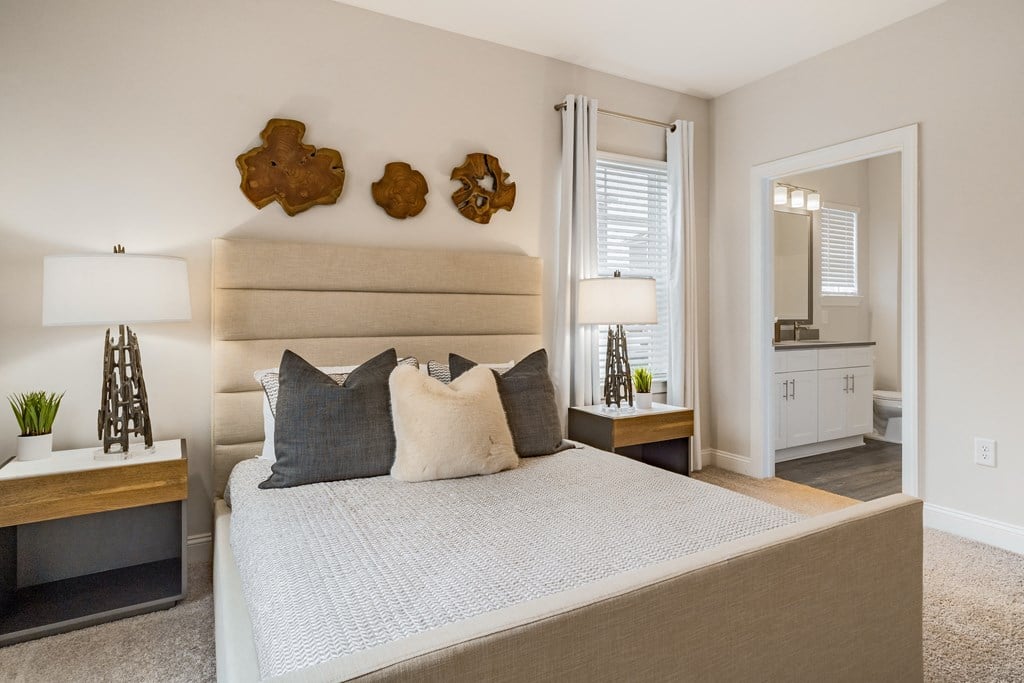 a bedroom with a large bed and a mirror