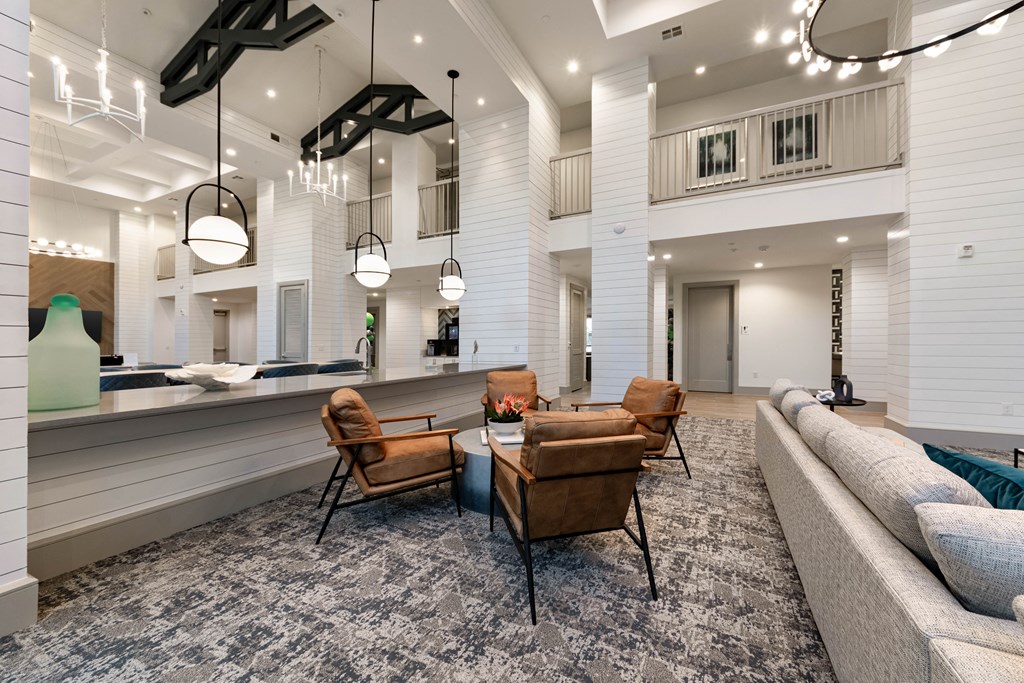 A modern living room with a grey carpet and wooden furniture.