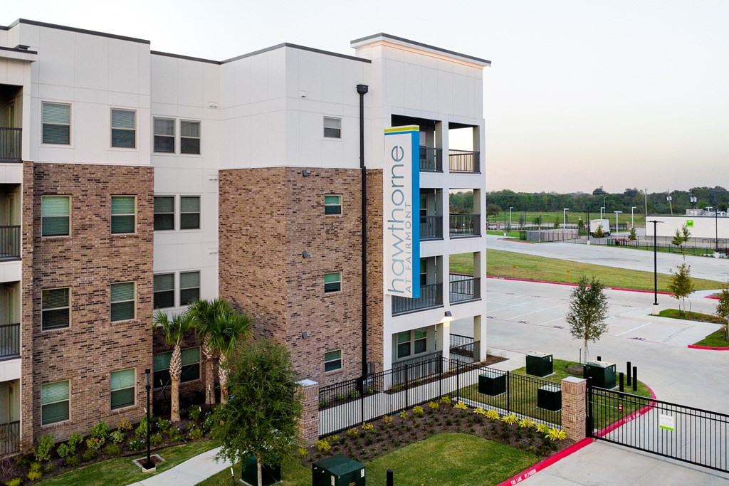 A multi-story apartment building with a sign that reads