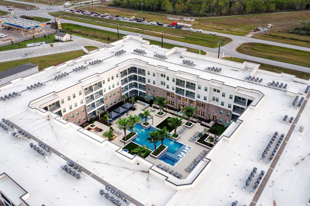 A large white building with a pool in the middle of it.