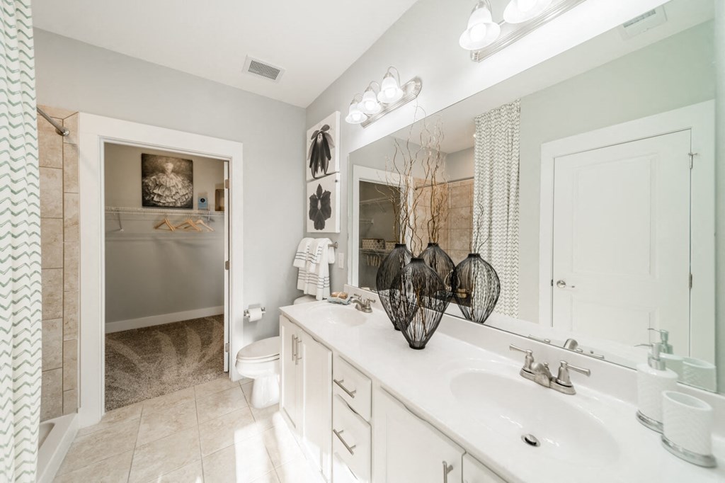 a bathroom with a sink and a toilet and a mirror
