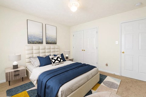 a bedroom with a bed and two closet doors