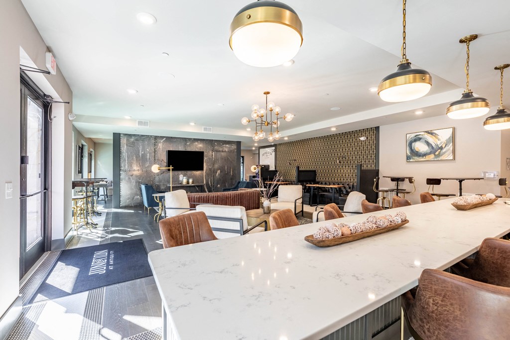 a communal table and chairs in a living room with a kitchen and dining area