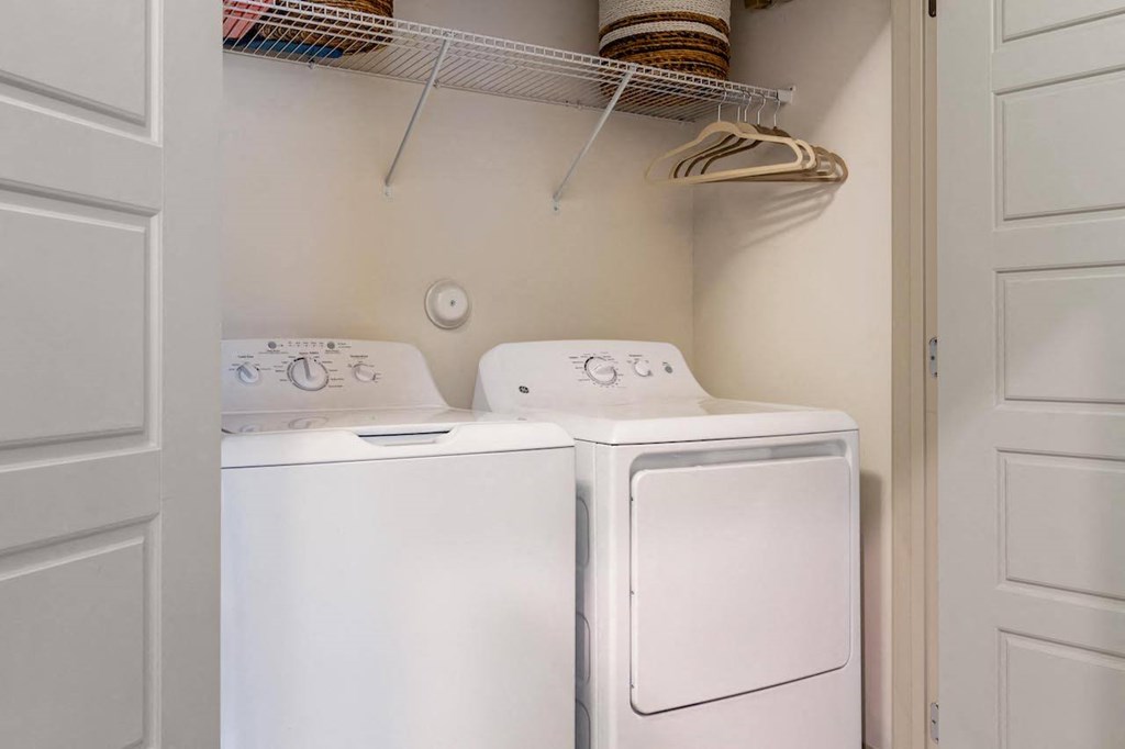 A white washing machine and dryer in a small laundry room.