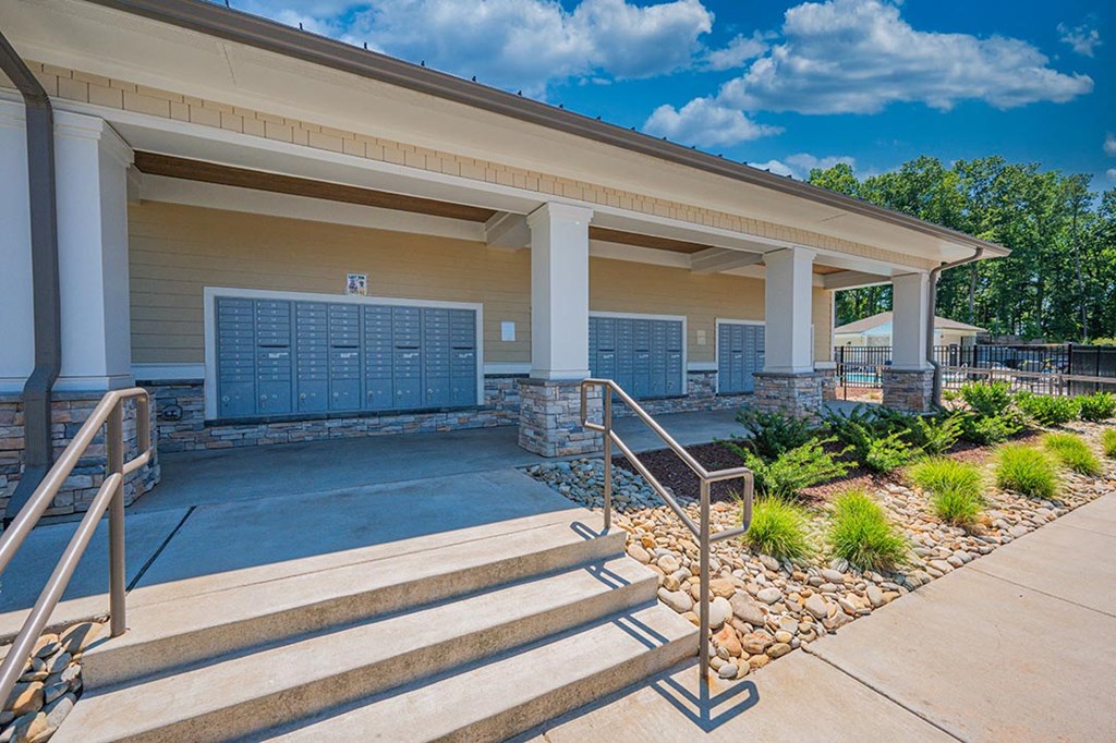 a building with stairs and a garage door in front of it