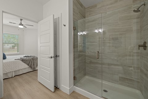a bathroom with a shower and a bed