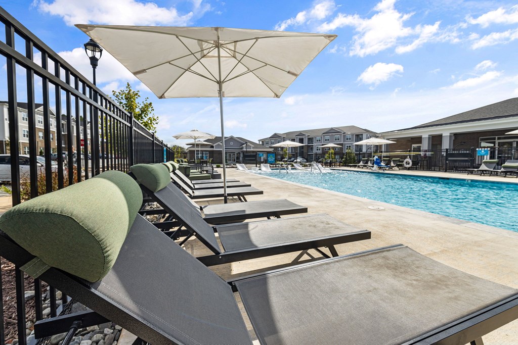 a group of lounge chairs next to a swimming pool