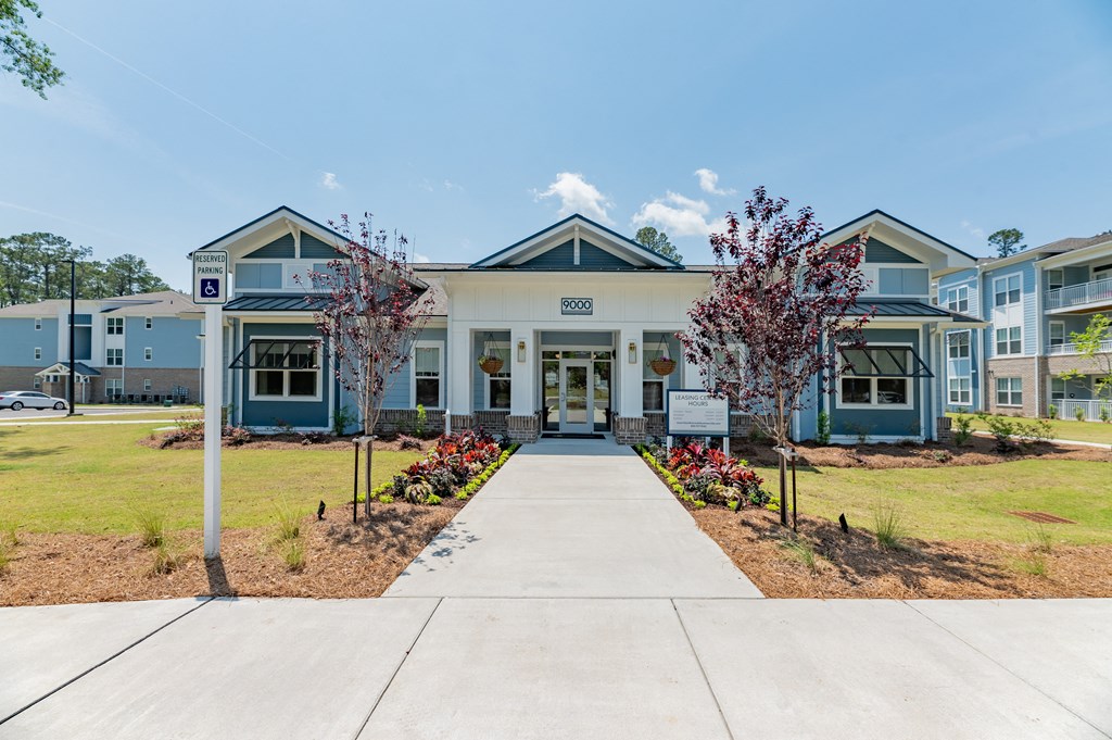 an exterior view of a building with a sidewalk in front of it