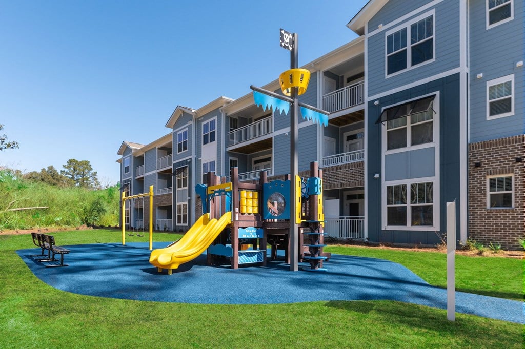 an outdoor playground at the flats at big tex apartments