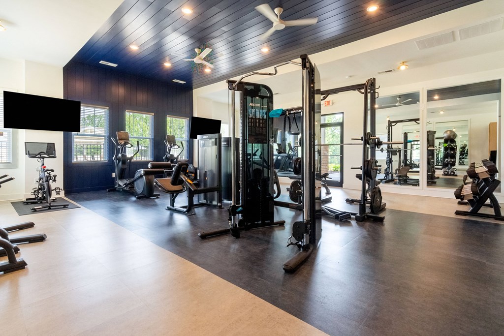 Amenities Highlight Large Fitness Center with Cardio and Weight Training Equipment