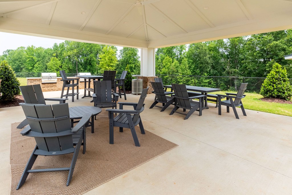 a covered patio with tables and chairs