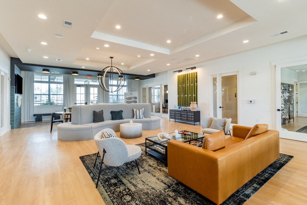 a living room filled with furniture and a large chandelier