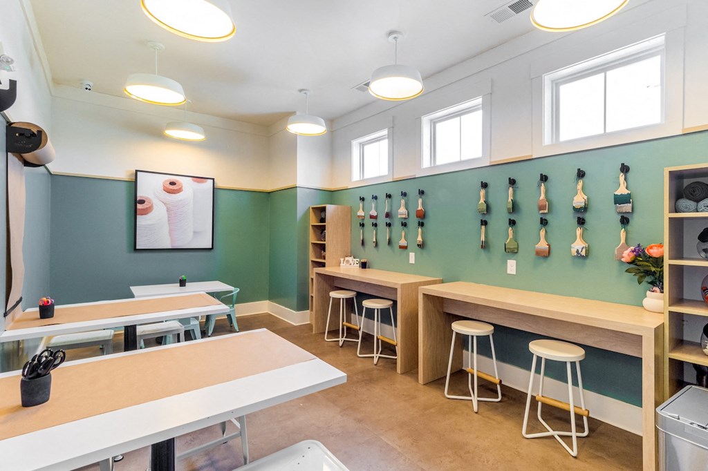 a room with tables and stools and squash rack on the wall
