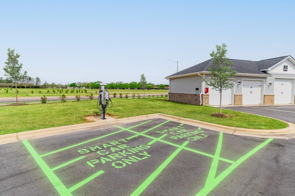 a parking lot with a message painted on it in front of a house