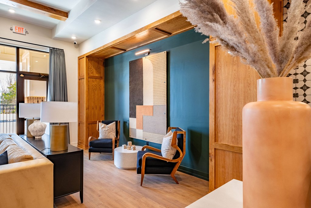 A room with a blue wall and a white vase.