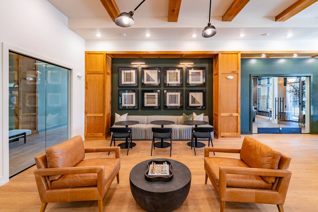 A living room with a brown leather chair and a black coffee table.