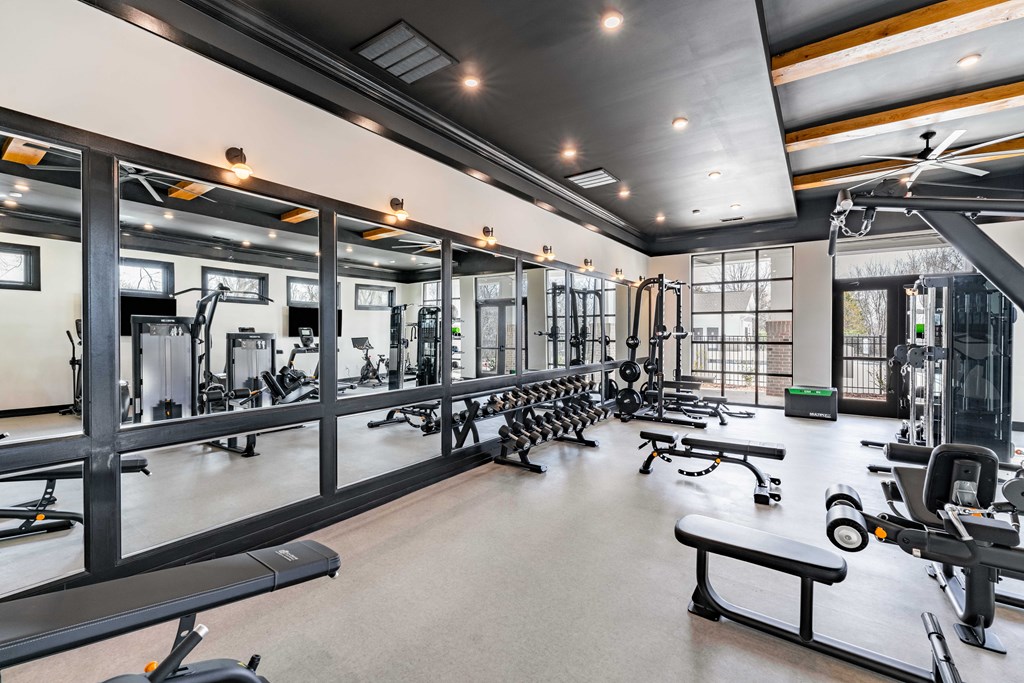 A spacious gym with a variety of equipment.
