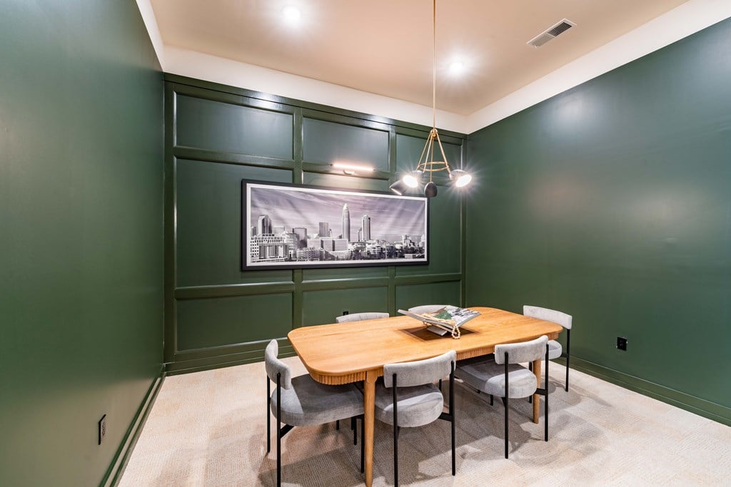 A dining room with a wooden table and chairs.